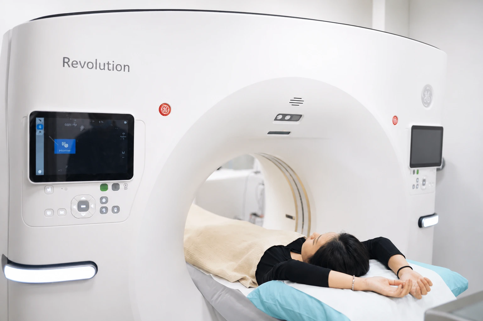 A patient lying on a CT scanner undergoing a low-dose CT calcium score scan at a Singapore clinic